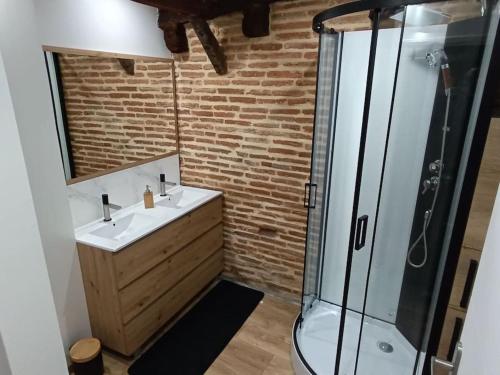 a bathroom with a sink and a shower at logement entier avec garage. in Rieux