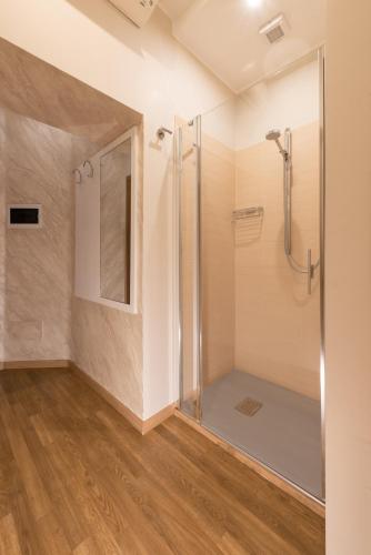a bathroom with a shower with a glass door at Top Floor Colosseo Guesthouse in Rome