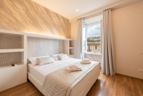 a bedroom with a bed with two towels on it at Top Floor Colosseo Guesthouse in Rome