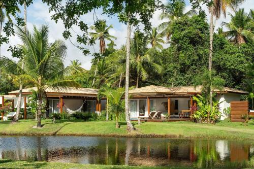 a house with a pond in front of it at Orixás Residence in Morro de São Paulo