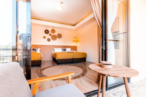 a living room with two beds and a table at Molly Resorts in Puerto Galera