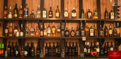 a bunch of bottles of alcohol on shelves at Hotel Montenegro in Struga