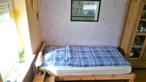 uma pequena cama num quarto com uma janela em Schwalm - Aue em Neuental