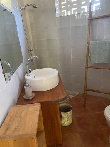 a bathroom with a sink and a toilet at Bazouk Du Saloum Ecolodge in Mar Lodj