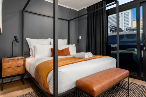 a bedroom with a large bed and a large window at The Tokyo 307 in Cape Town