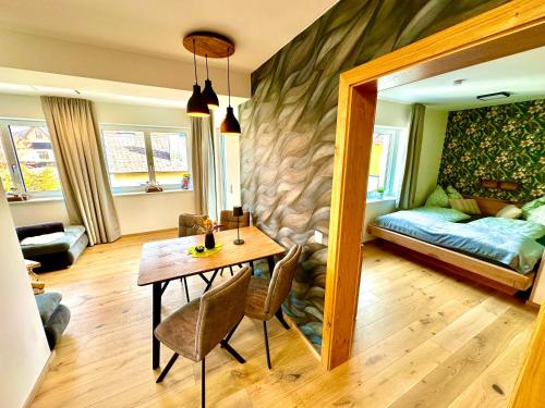 a living room with a table and a couch at Appartement Bergmann in Ebensee