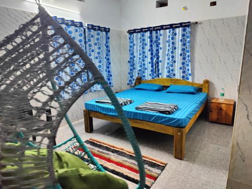a bedroom with a bed and a hammock at ArtKarna in Gokarna