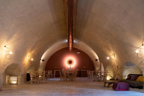 a room with tables and chairs in a tunnel at Antica Masseria le Monache in Grottaglie