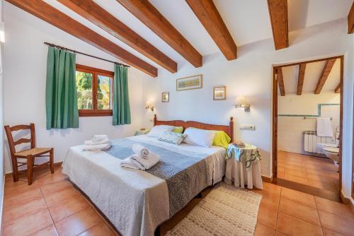 a bedroom with a bed with towels on it at Villa Llompart Pollensa by JS Villas in Pollença
