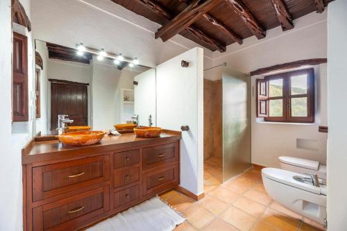 a bathroom with two sinks and a toilet at Finca with Pool Sant Joan in San Juan Bautista