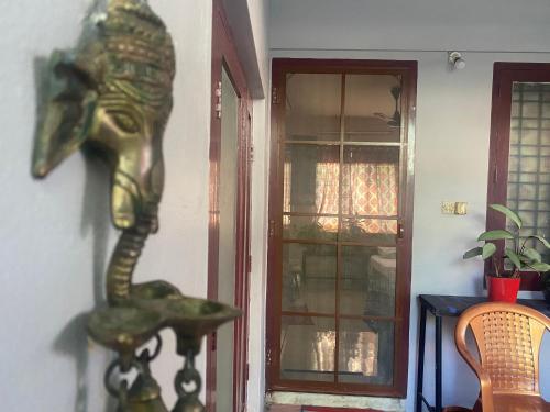 a statue of a lizard on a wall next to a door at Homestay - Heaven Aumgarden in Trivandrum