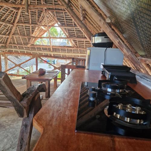 a kitchen with a stove and a wooden counter top at TIANDE Boutique Hotel in Pwani Mchangani