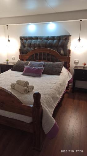a bedroom with a large bed with two towels on it at Villa Anita Spa in Piriápolis