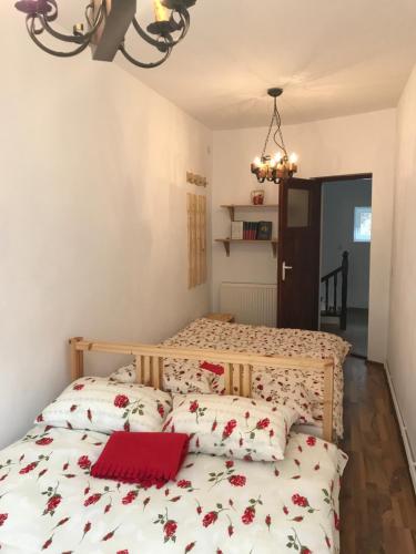 a bedroom with a bed with a red laptop on it at Trei Tulnice in Rau Sadului