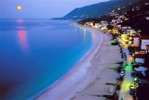 a view of a beach at night with the moon at Archontiko Michael Pelion in Vizitsa