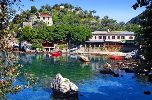 a river with a group of buildings on a mountain at Archontiko Michael Pelion in Vizitsa