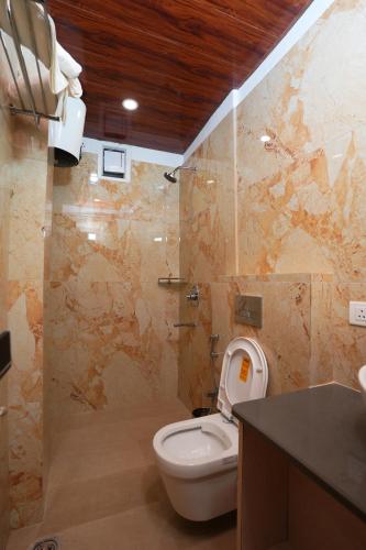 a bathroom with a toilet and a sink and a counter at Anaya Retreat in Varanasi