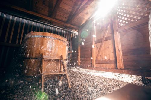 a wooden barrel sitting in a room with the sunlight at Apartmán-Hotel Jítravský Dvorec in Rynoltice
