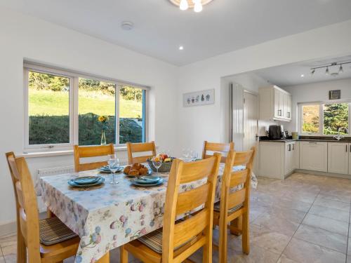 a kitchen and dining room with a table and chairs at Teach Eile, Clifden in Clifden