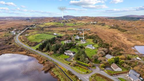 an overhead view of a house and a road next to a lake at Teach Eile, Clifden in Clifden