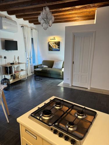 a kitchen with a stove top in a living room at Ca Penini - canal view in Venice