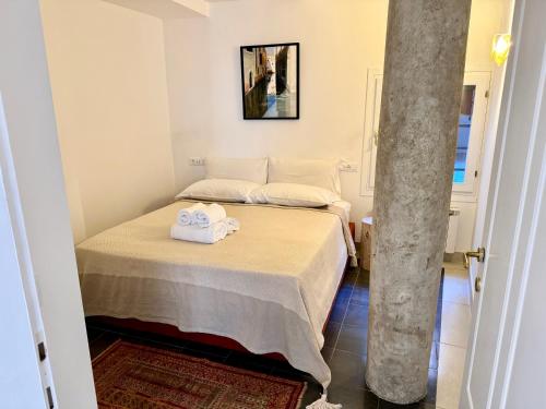a bedroom with a bed with towels on it at Ca Penini - canal view in Venice