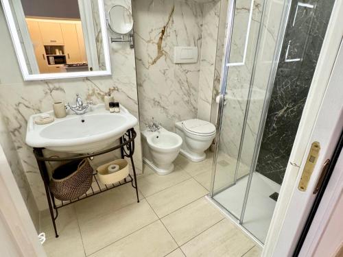 a bathroom with a shower and a sink and a toilet at Ca Penini - canal view in Venice