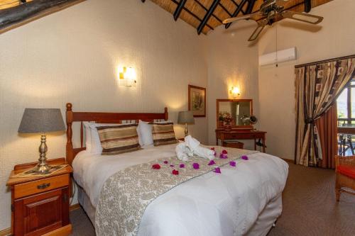 a bedroom with a bed with flowers on it at Kruger Park Lodge Unit No. 516 in Hazyview