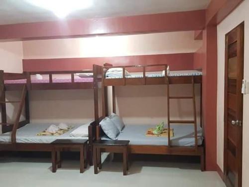 a room with two bunk beds in a room at D'MESA Seacretlodge and Restaurant in Taytay