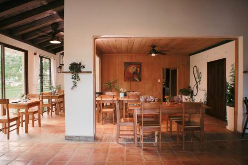 a dining room with wooden tables and chairs at Hidden Valley Wilderness Lodge in San Ignacio