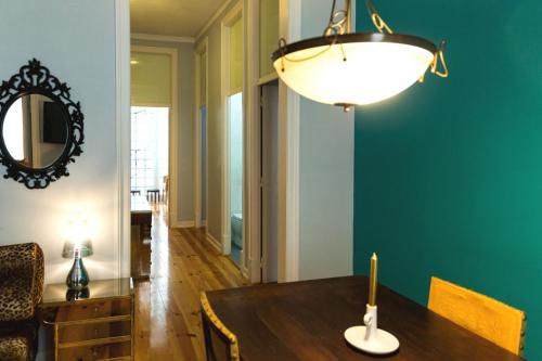 a dining room with a table and a light fixture at Lisbon Art Stay Apartments Baixa in Lisbon