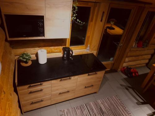 a kitchen with a sink and a counter top at Ezerkalni in Raiskums