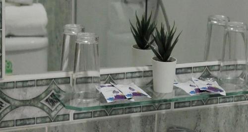 a glass shelf in a bathroom with a mirror at Hostal Al-Andalus in La Guijarrosa