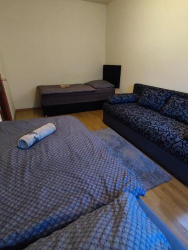 a living room with two beds and a couch at Váralja Vendégház Tata in Tata