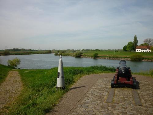 a toy car and a cone on the side of a river at Het Molenaarshuis in Thorn