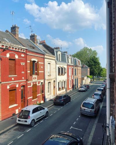 a city street with cars parked on the street at Bienvenue au parc St Pierre in Amiens