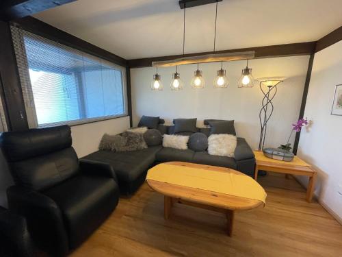 a living room with a couch and a table at Holiday Home Jägerwiesen-8 by Interhome in Waldkirchen