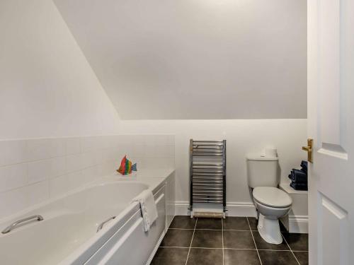 a white bathroom with a tub and a toilet at 3 bed property in Sturminster Newton Dorset RCORN in Sturminster Newton