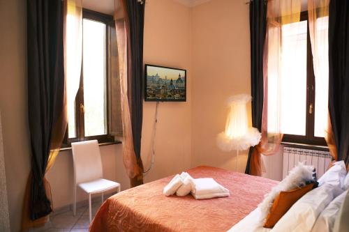 a bedroom with a bed with two towels on it at Luxury Domus in Rome