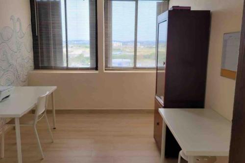 a room with a white table and two windows at Attractive Penthouse in Isla Verde in San Juan