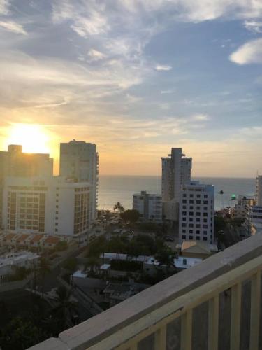 a view of a city with the ocean and buildings at Attractive Penthouse in Isla Verde in San Juan