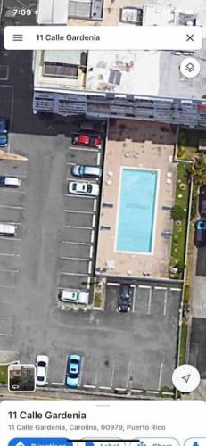 an overhead view of a parking lot with a pool at Attractive Penthouse in Isla Verde in San Juan