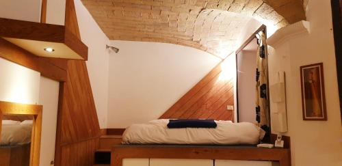 ローマにあるCharming Loft Trastevereの木製の天井が特徴の屋根裏部屋(ベッド1台付)