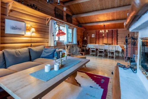 a living room with a couch and a table at Trysilfjellet sør 318 in Trysil