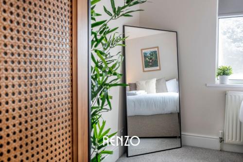 a mirror in front of a bedroom with a bed at Vibrant 3-bed House in Nottingham by Renzo, Amazing Location, Sleeps 6! in Nottingham
