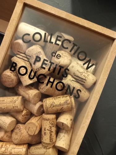 a pile of wine corks in a wooden frame at L'Anthacite Gite 8 à 12 personnes in Courlaoux