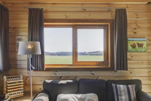 a living room with a couch and a window at Ecolodge 1 in Medebach