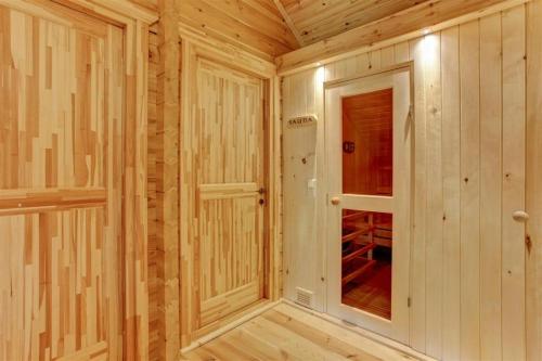 a small room with wooden walls and a door at Ecolodge 1 in Medebach