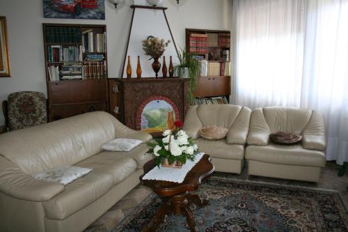 a living room with two white couches and a table at B&B Il Glicine in bedizzol