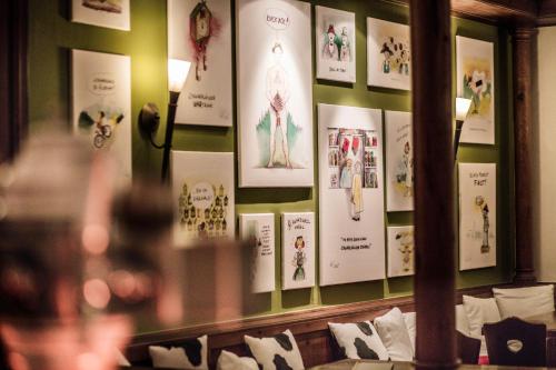 a wall with posters on it with pillows at Schwarzwald Panorama in Bad Herrenalb